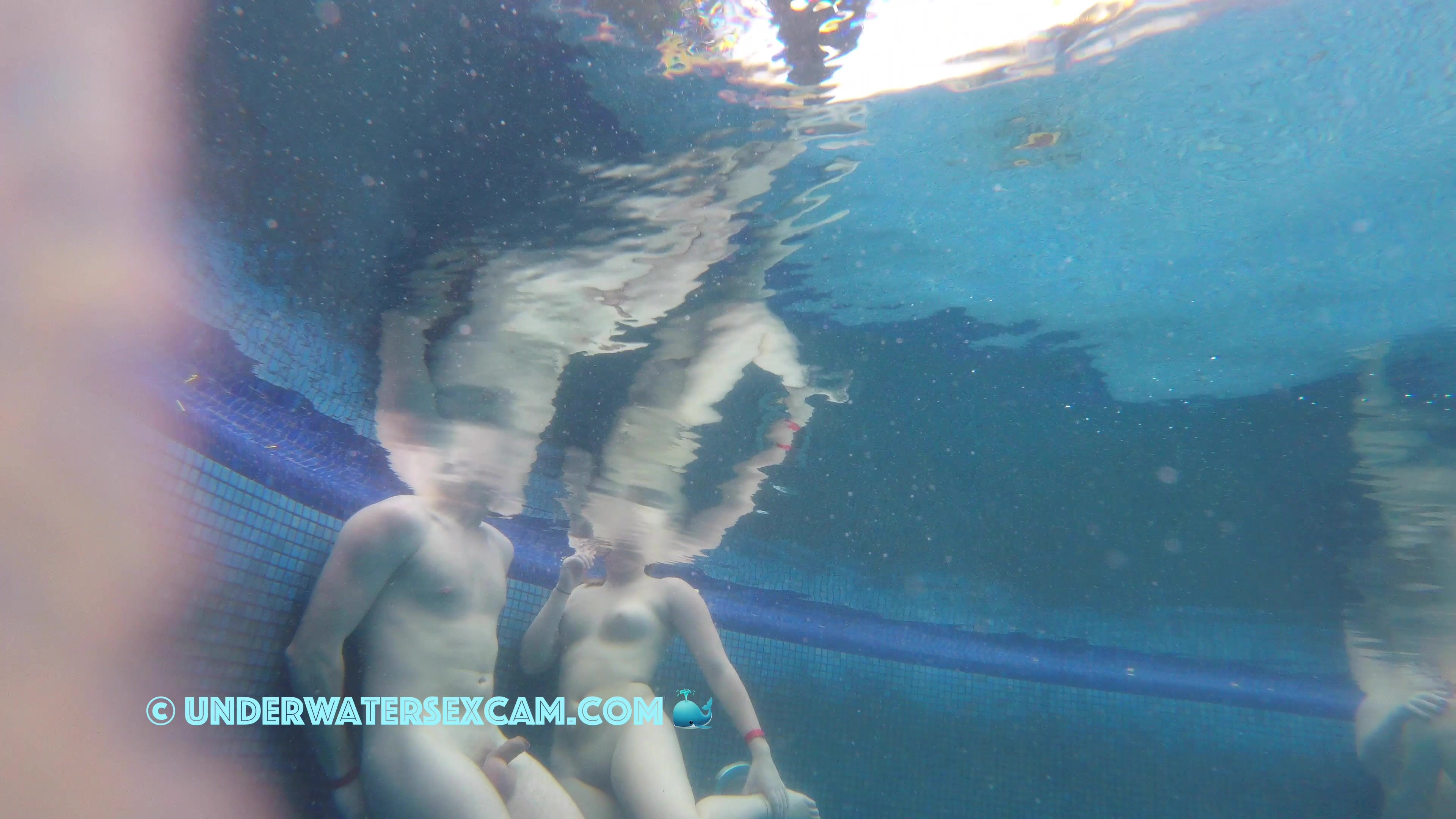 A pretty couple flirting underwater