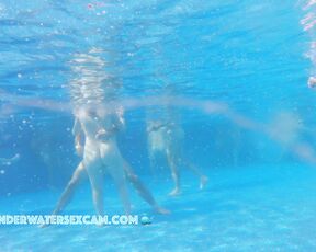 Nude couple in a full public pool