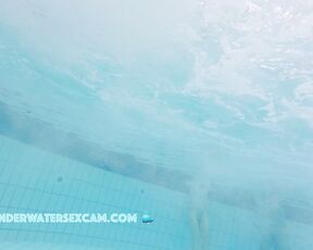 Nice girl likes two flow on underwater stairs