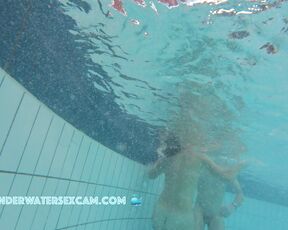 Nice girl likes two flow on underwater stairs