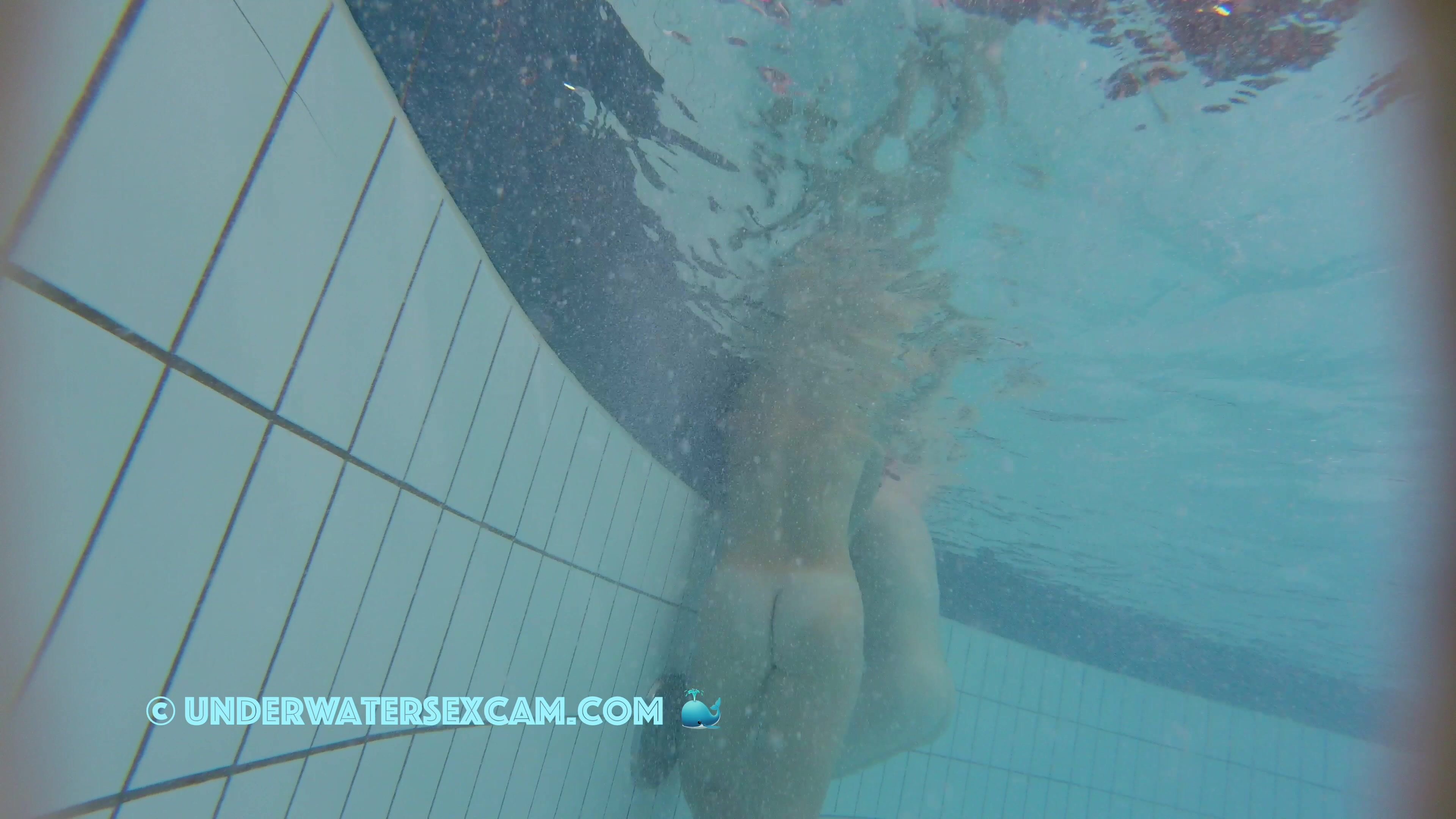 Nice girl likes two flow on underwater stairs