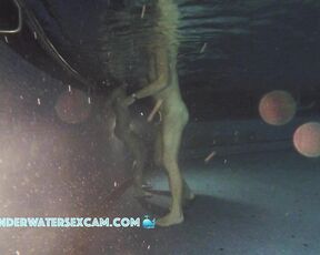Nudist couple at night in a public pool
