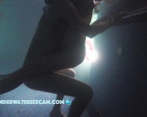 Man holding his wife for underwater massage