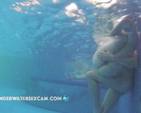 Young couple gets horny in a public pool