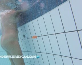 She tests the massage jet in a public pool