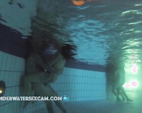 Biker couple with many tattoos plays underwater