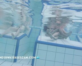 Happy nudist people on an underwater bench