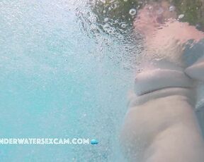 Elder lady has fun with underwater bubbles