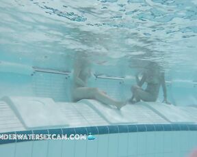 Two nudist girls on an underwater bench