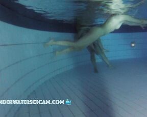A naked mermaid swims by at night