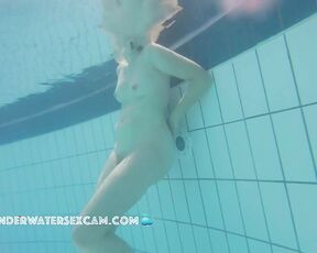 Natural woman alone and nude in the pool