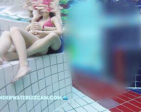 Teen couple is playing together in a public pool