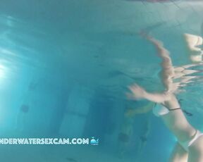 Cute teen girl enjoys an underwater massage