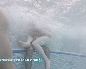 A very white girl hangs out on a very brown boy while the jacuzzi is running