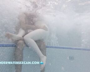 A very white girl hangs out on a very brown boy while the jacuzzi is running