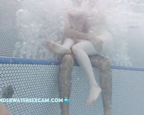 A very white girl hangs out on a very brown boy while the jacuzzi is running