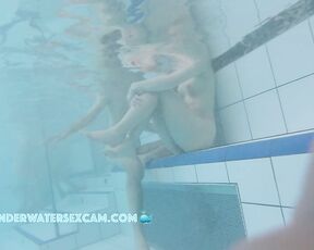 A pretty young couple talking while nude on an underwater bench