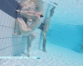 A really pretty naked girl holds on to the edge of the pool and is being filmed underwater with a hidden camera.