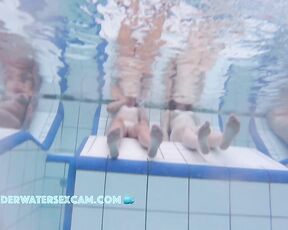 Some cute young girls on an underwater bench in a sauna pool