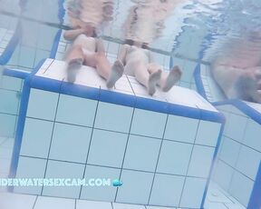 Some cute young girls on an underwater bench in a sauna pool