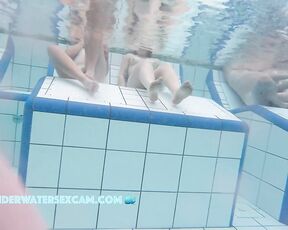 Some cute young girls on an underwater bench in a sauna pool