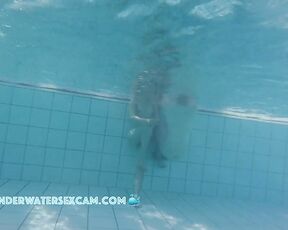 Cute young couple is surprised by the feeling of being completely naked in the water