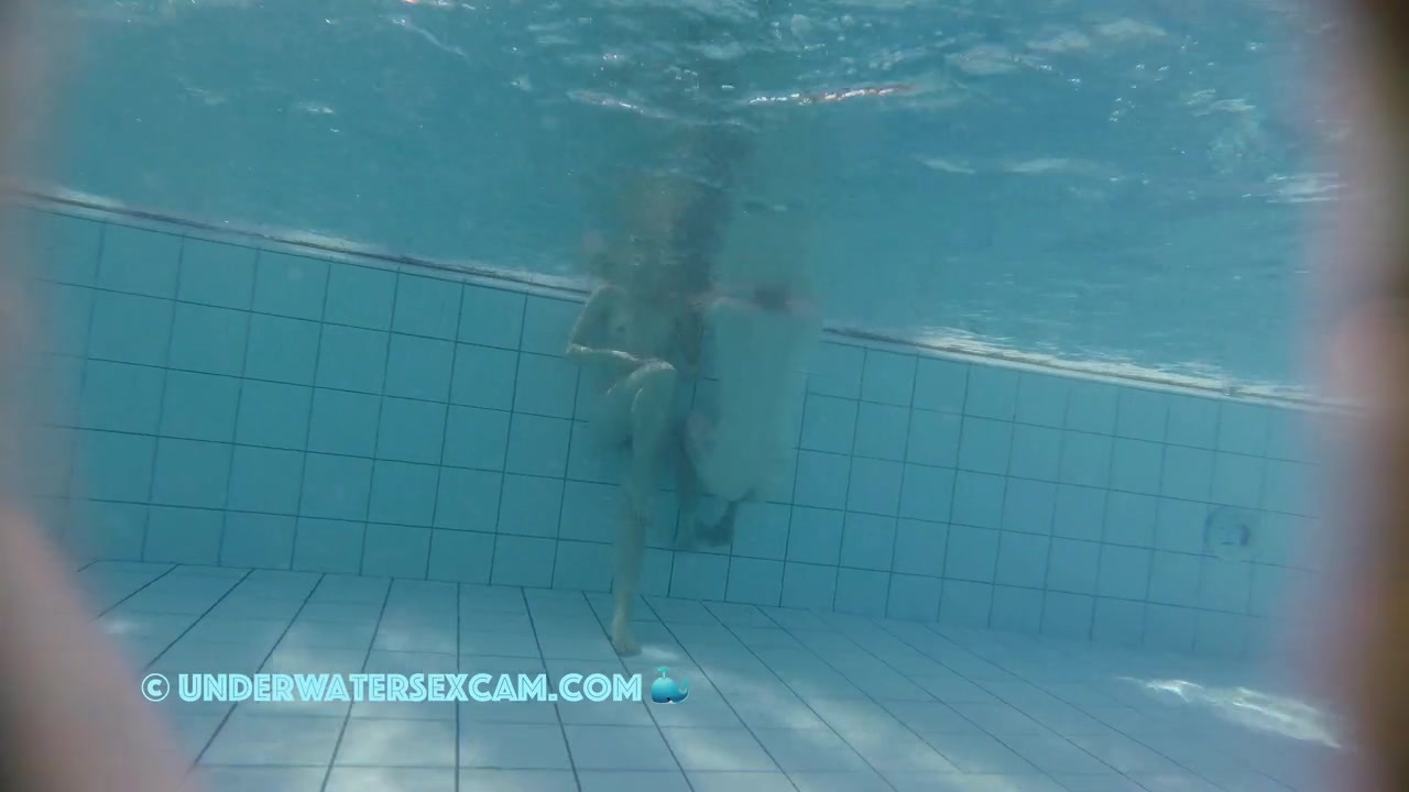 Cute young couple is surprised by the feeling of being completely naked in the water