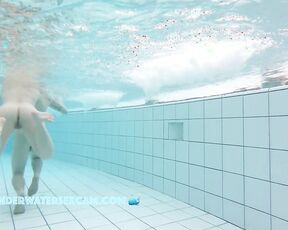 She has fun making him horny while they both take a naked bath in the public swimming pool