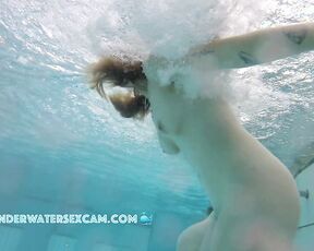 This lady enjoys the underwater massage in a public nudist resort