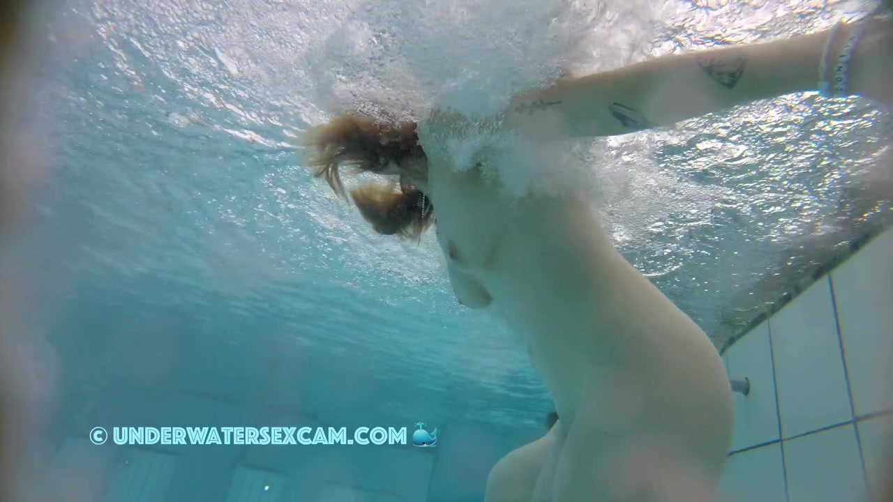 This lady enjoys the underwater massage in a public nudist resort