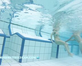 Awesome girls with amazing boobies lying on an underwater bench