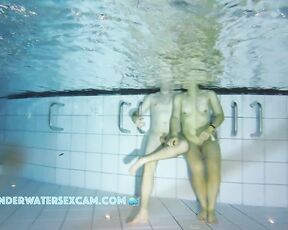 This young couple stands perfectly in the light of the underwater spotlight