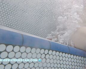 A pretty young woman is having fun with the Jacuzzi bubbles and I watch her do it