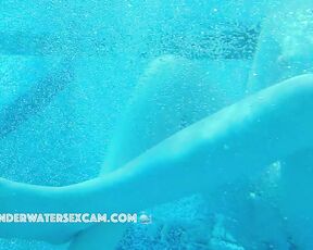 NEW! One of these young students smiles at me as she sticks her finger in underwater