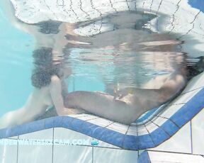 NEW! A young couple visibly enjoys playing together naked in the pool