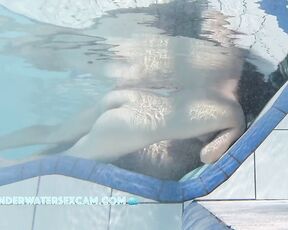 NEW! A young couple visibly enjoys playing together naked in the pool