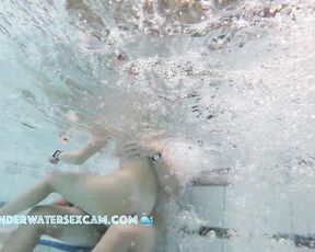 NEW! A young couple plays together in a large public jacuzzi.