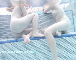 NEW! The two cute girls have this sexy way of sitting, but only because they're naked.