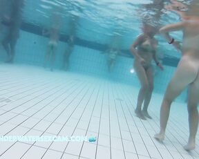 This teen girl with almost no breasts dances around a bit in the sauna pool.