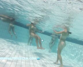 This teen girl with almost no breasts dances around a bit in the sauna pool.