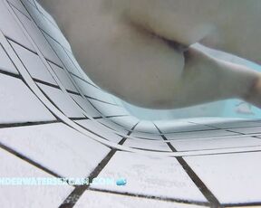 This delicate girl is trying out the massage jets in the underwater loungers.