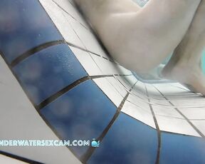 This delicate girl is trying out the massage jets in the underwater loungers.