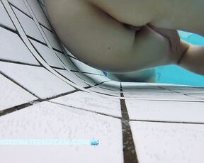 This delicate girl is trying out the massage jets in the underwater loungers.
