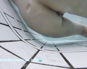 This delicate girl is trying out the massage jets in the underwater loungers.