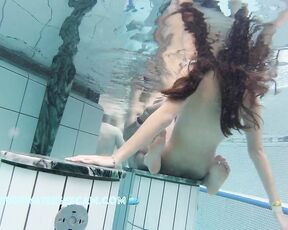 NEW! This young couple clearly feels right at home in the warm water of the sauna pool, and so does the voyeur filming them