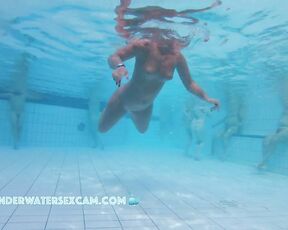 NEW! Look at the guy in the background, busily masturbating with the underwater jet while staring at the hot girl in the foreground.