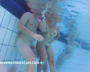 NEW! Not only is this MILF turning her man on, but the guy in the background starts masturbating, too.